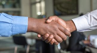 Two African American men shaking hands.