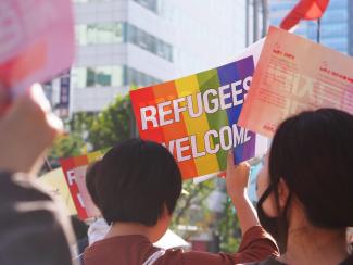 Group of people welcoming LGBT refugees.